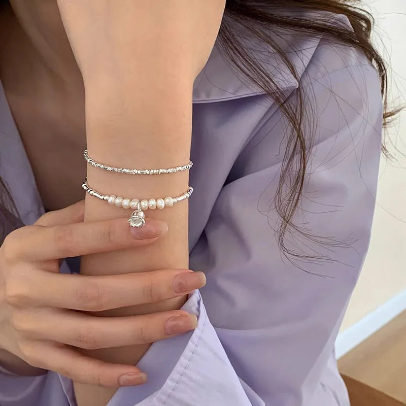Silver pearl Lily of the Valley pendant bracelet on display
