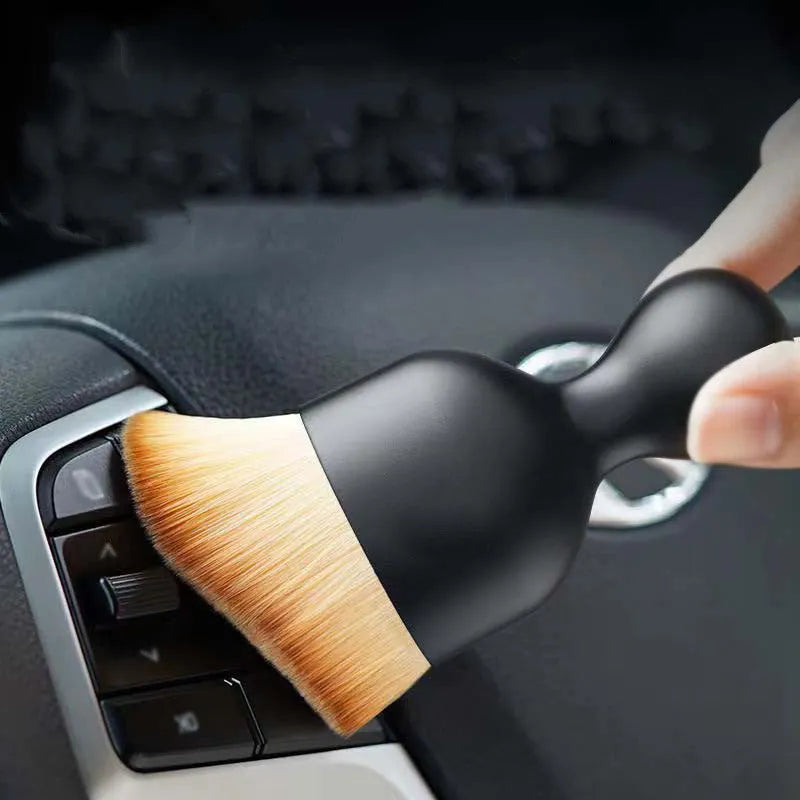 Compact white PVC car interior cleaning brush for dusting dashboard and vents.