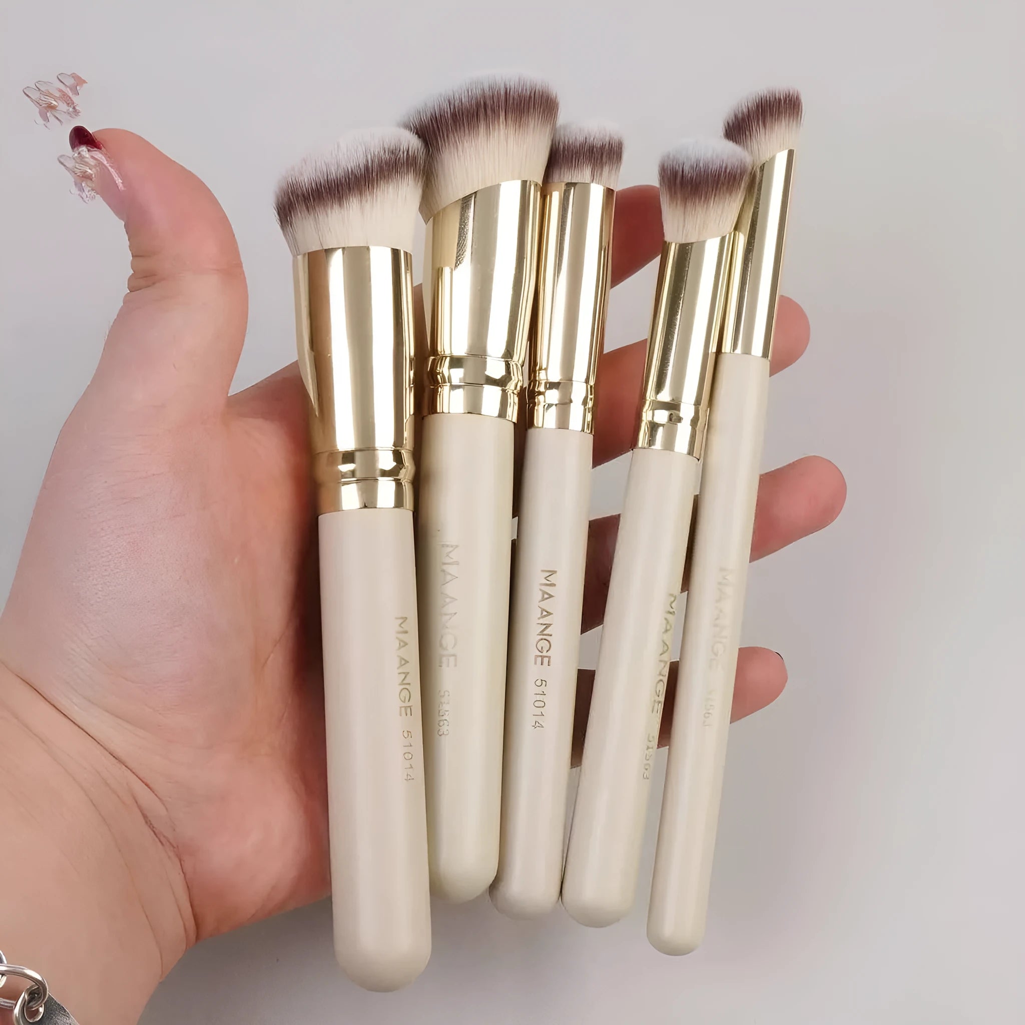 Five angled apricot makeup brushes for blush and contour application