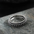 Geometric triangular ring with a zircon stone inlay, shown in white gold, yellow gold, and white and black finishes.