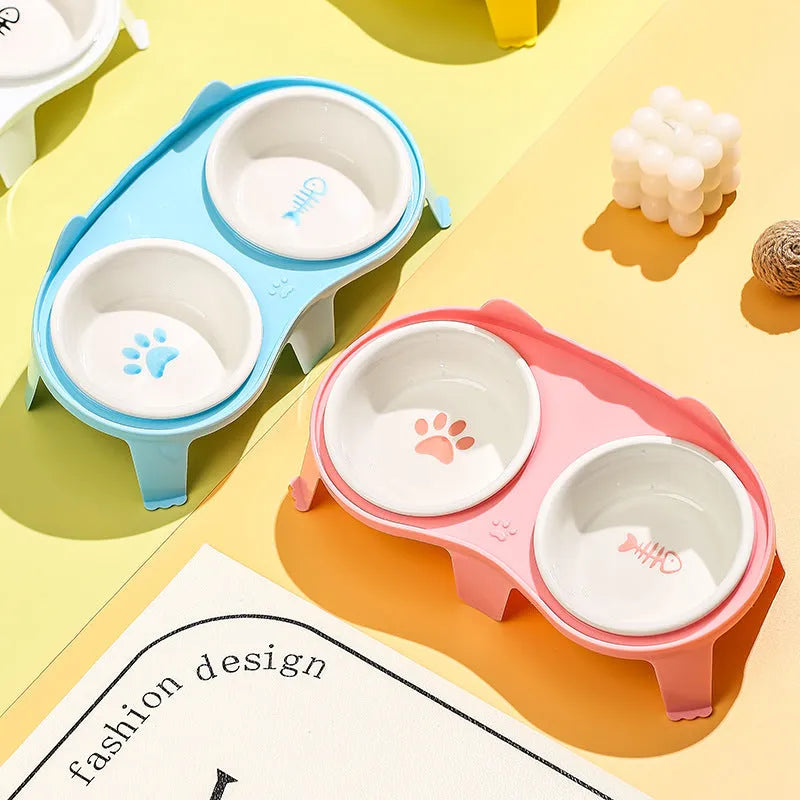 Ceramic cat bowl set with elevated tilted feeding stand in blue, pink, white, and yellow colour options
