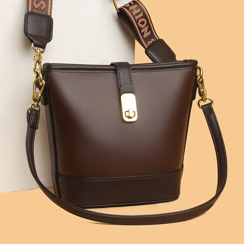 Korean-style black bucket messenger bag showing zipper compartments and adjustable shoulder straps