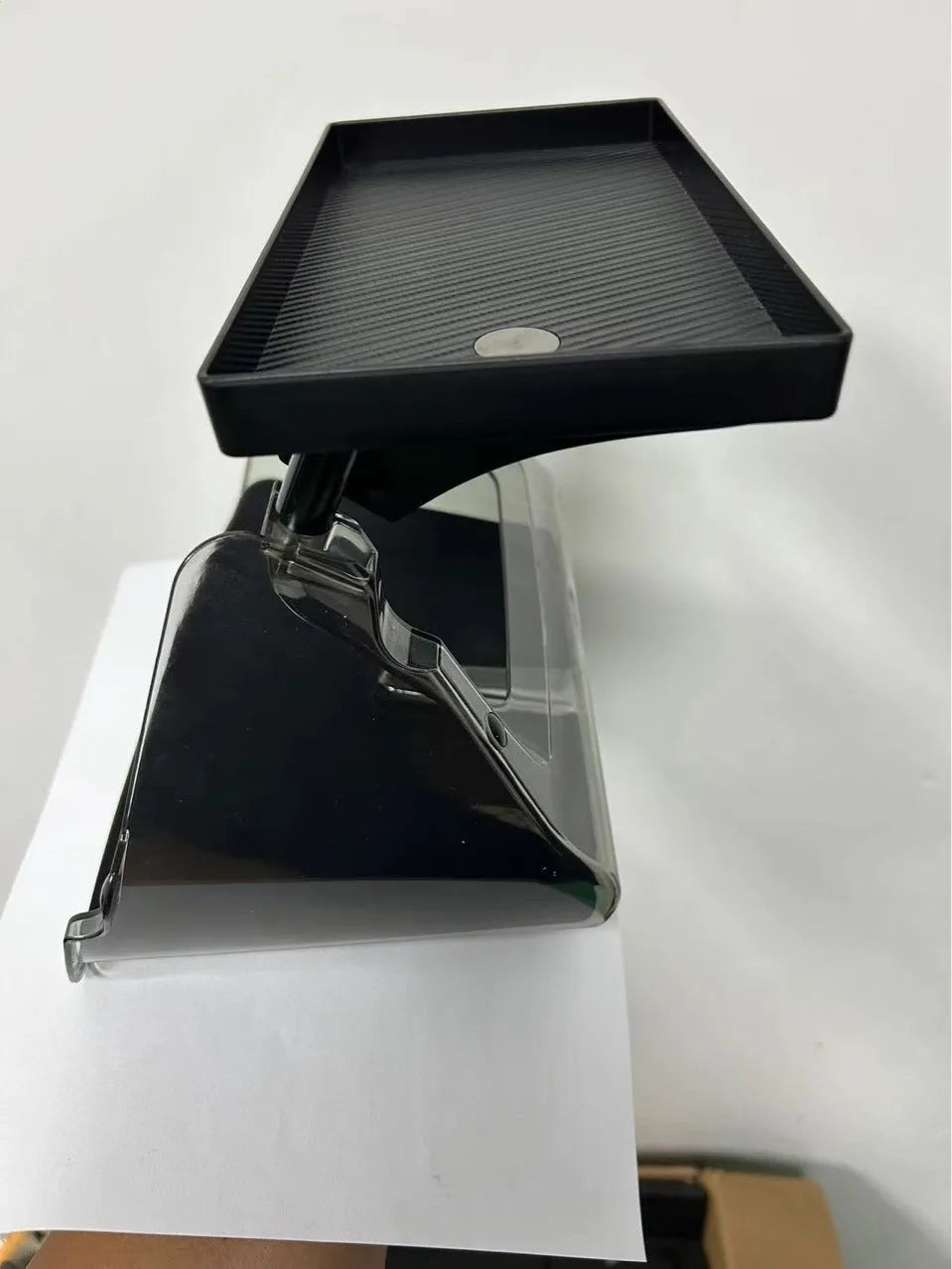 Black ABS storage box for Tesla Model 3 and Y, positioned under the centre touchscreen.