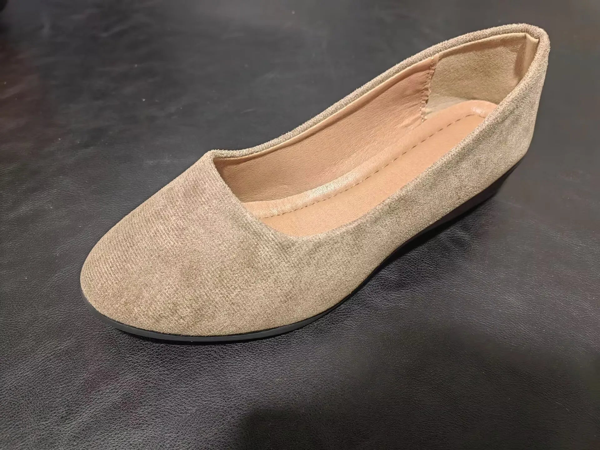 Women's light brown suede wedge pumps with a pointed toe and shallow mouth design on a rubber sole.