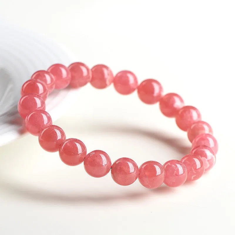 Women's red rhodochrosite crystal bracelet with geometric beads and longevity lock clasp