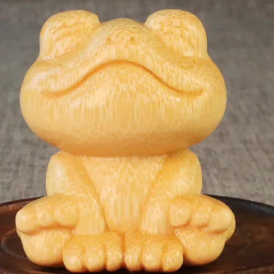 Solid bamboo smiling frog carving ornament measuring 5cm height with cartoon style design