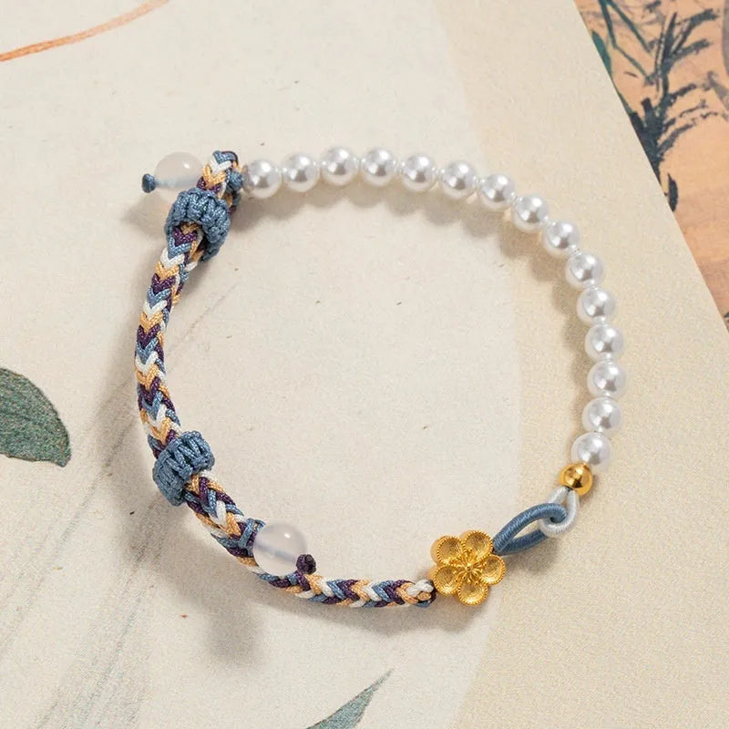 Peach-coloured Chinese flower weaving carrying strap bracelet with pearl accents on cord material