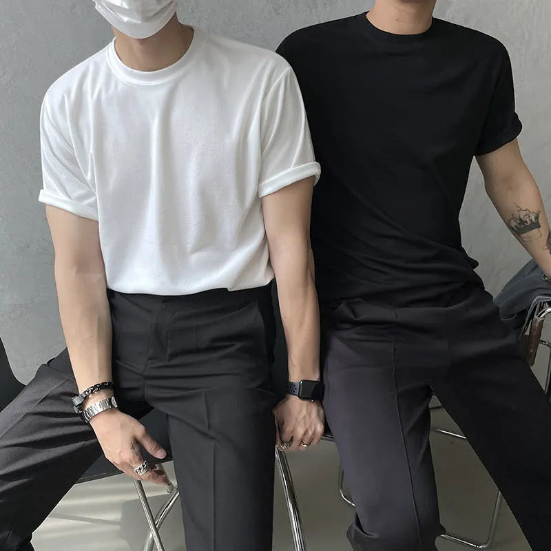 Men's slim fit solid colour cotton t-shirt on a model, showing round neck and half sleeves in white or black.