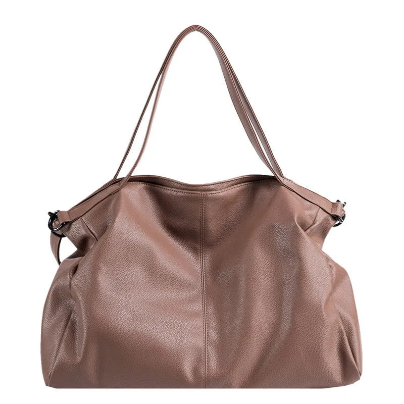 Large horizontal square soft PU messenger bag with zip and adjustable strap in four colour options.