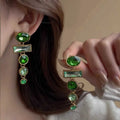 A pair of green gradient geometric drop earrings with alloy tassels and an inlaid zircon stone.