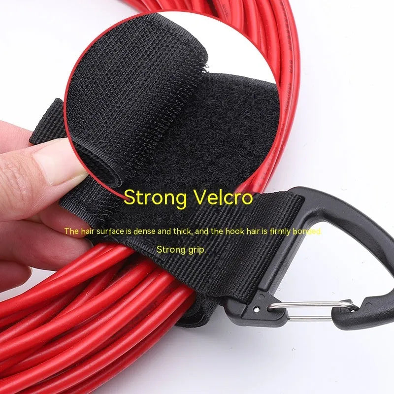 Black heavy-duty carabiner storage strap showing the climbing carabiner hook and 38mm wide blended material.