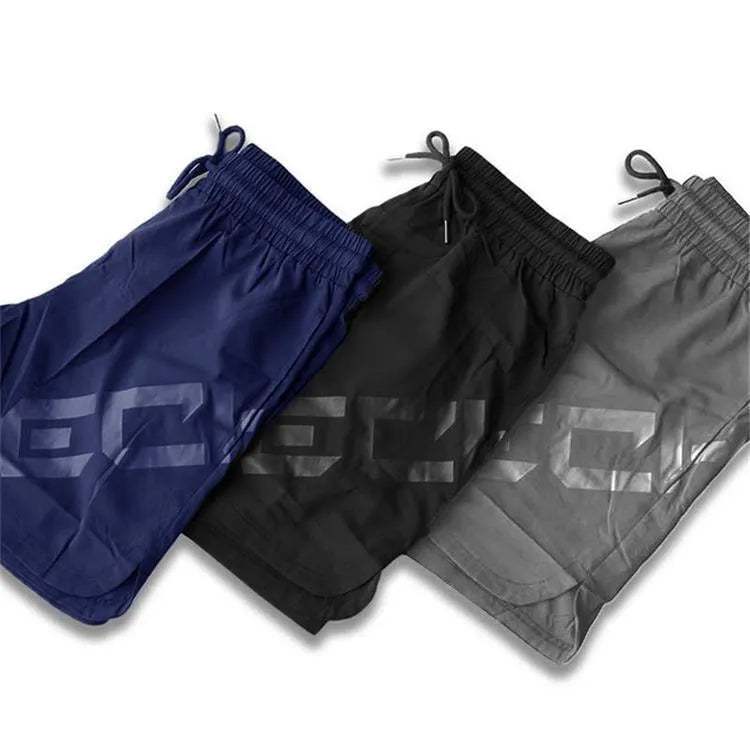 Men's black knee-length training shorts with an elastic waistband, made from quick-dry nylon blend fabric.