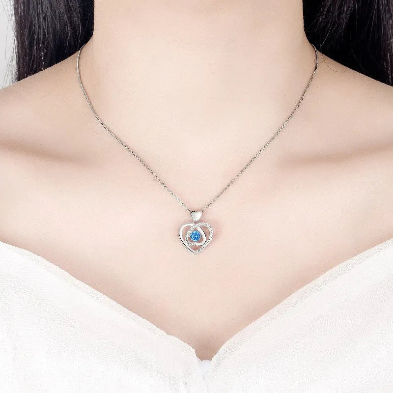 Blue electroplated heart pendant necklace and matching bracelet set with geometric design and gem inlaid detail