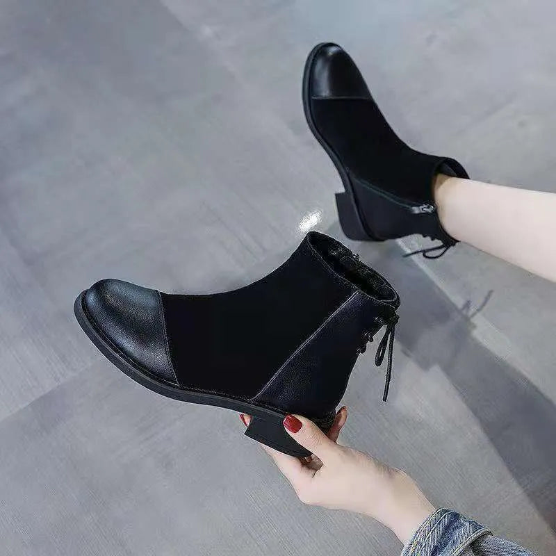 Black women's side-zip Martin boots with a round toe and short heel on a non-slip sole.