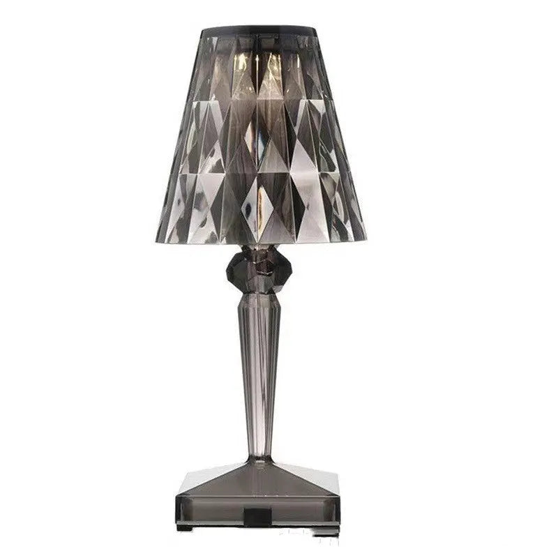 Rose gold portable touch control night light on a table.
