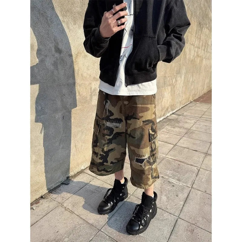 Men's loose camouflage cropped jeans with ripped knees and retro patch detailing on a thin cotton fabric.