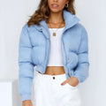Women's loose blue polyester jacket with long sleeves on a hanger