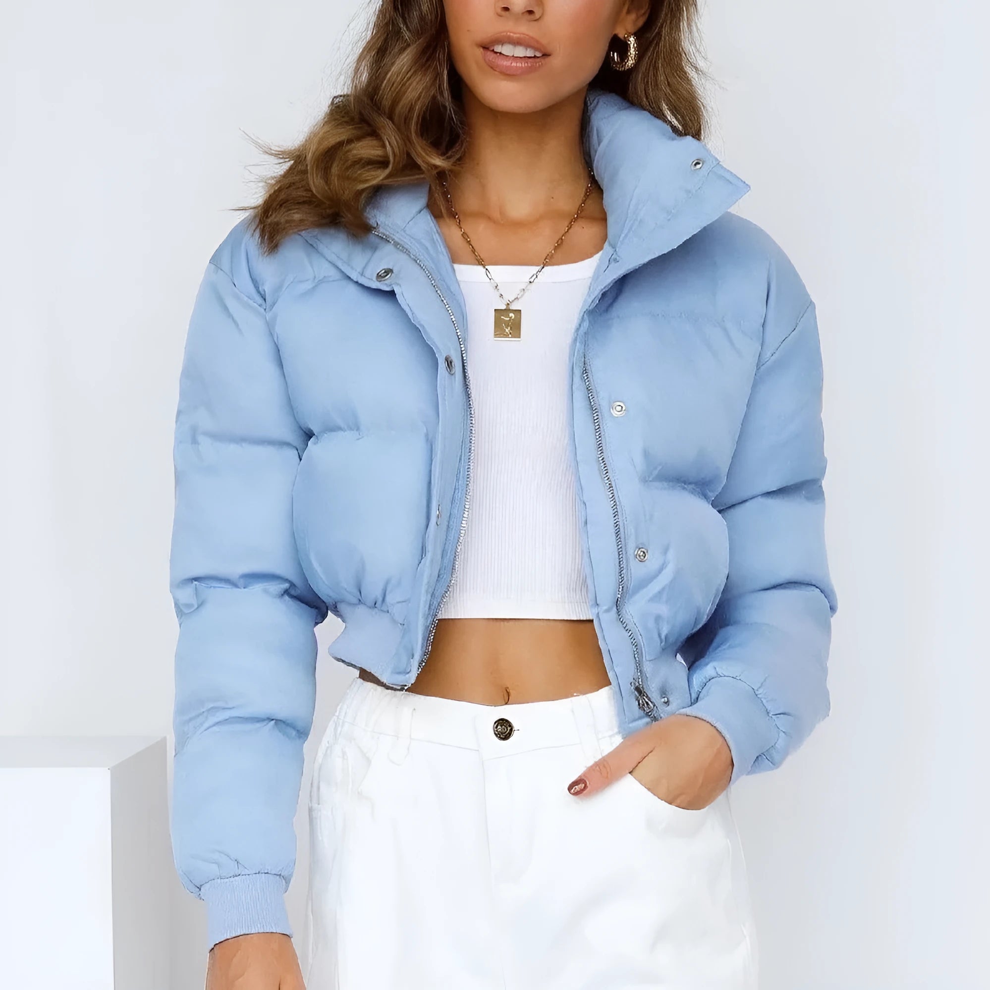 Women's loose blue polyester jacket with long sleeves on a hanger
