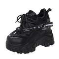 White women's low-top platform trainers with breathable mesh and a black cross-strap.