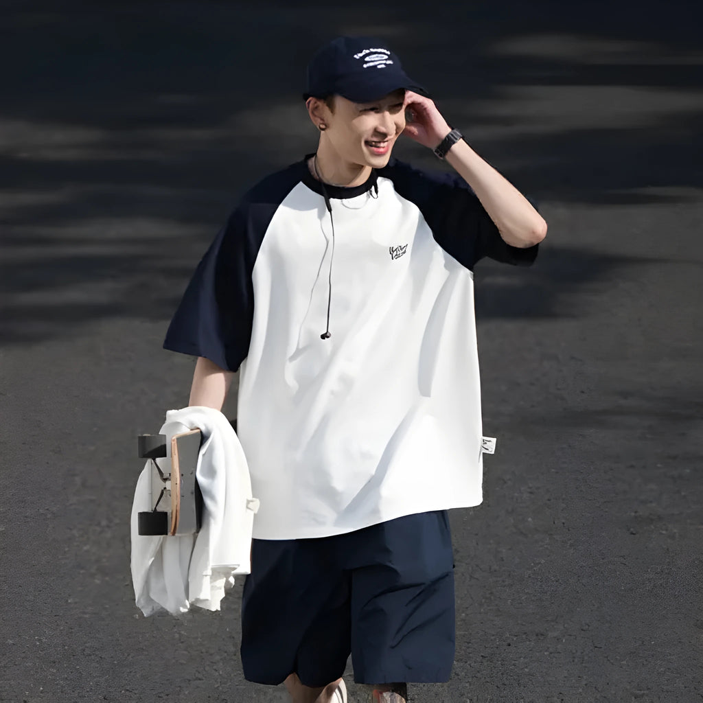 Blue casual men's t-shirt with raglan sleeves on a hanger, showing loose fit.