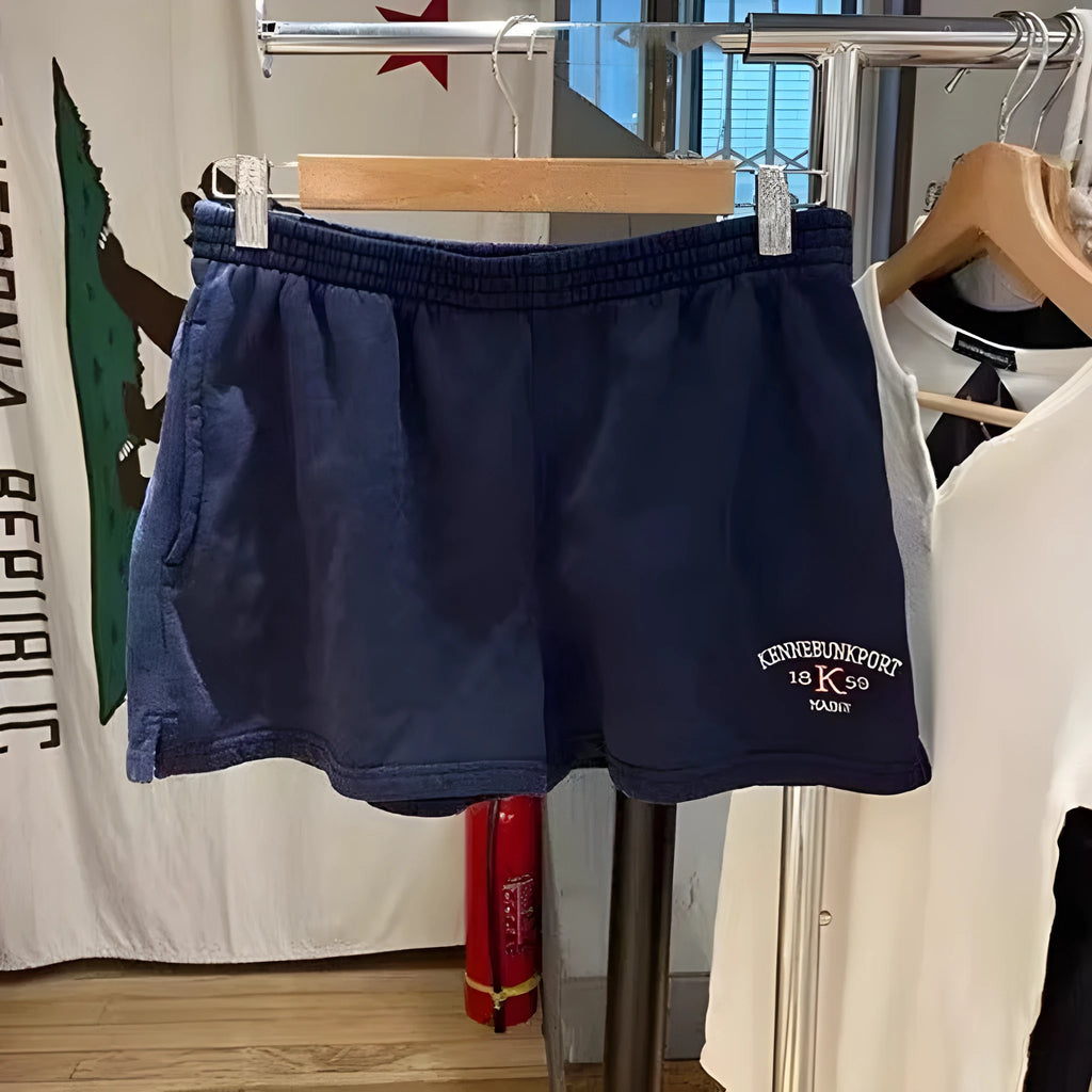 Women's dark blue cotton high-top sports shorts with white flag embroidery, shown in a free size fit.