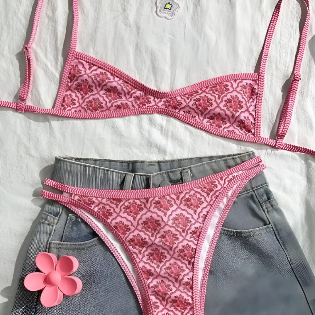 Printed pink split bikini set with exposed back and adjustable shoulder straps on woman