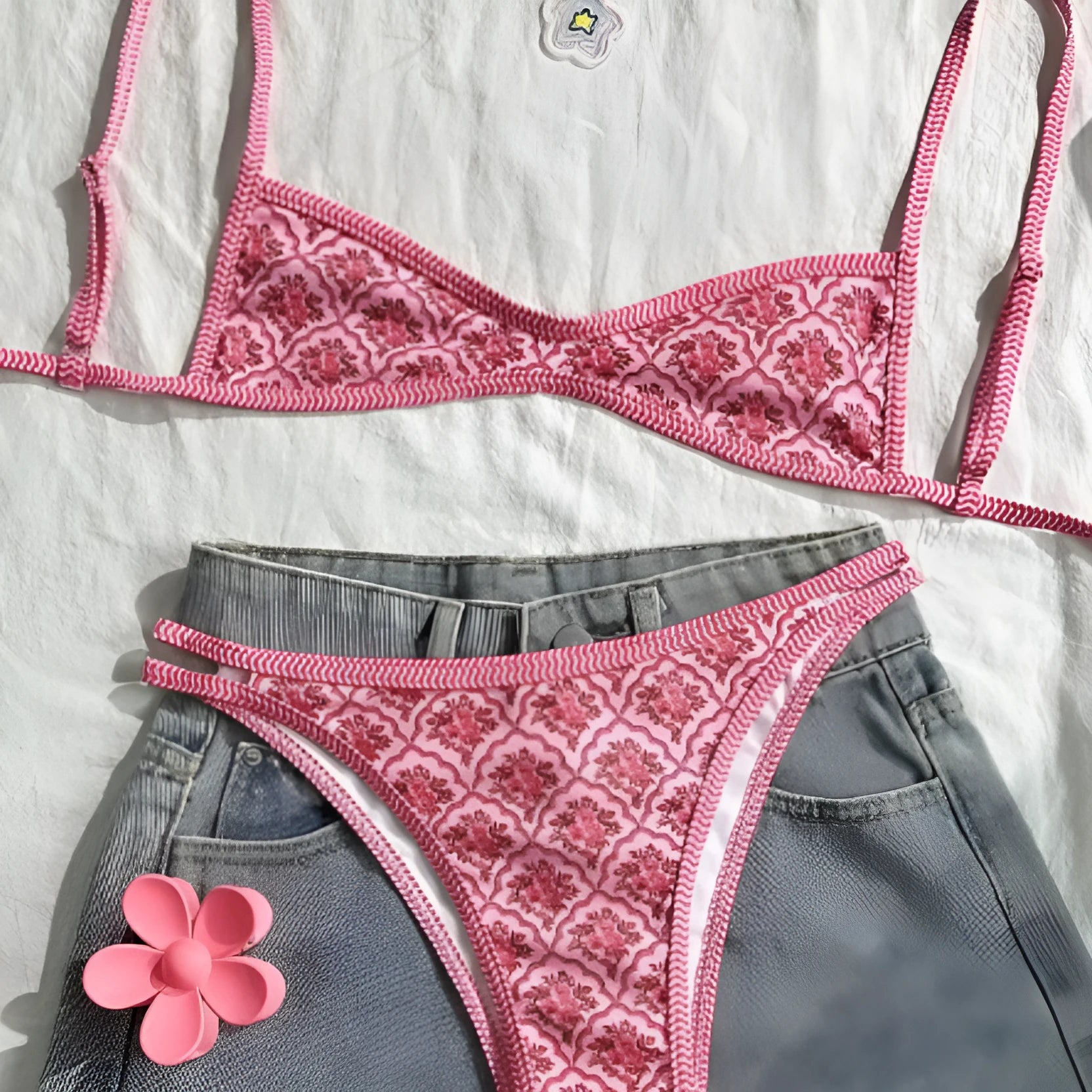 Printed pink split bikini set with exposed back and adjustable shoulder straps on woman