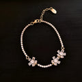 Gold-coloured copper women's bracelet with geometric shapes and inlaid zircon stones.