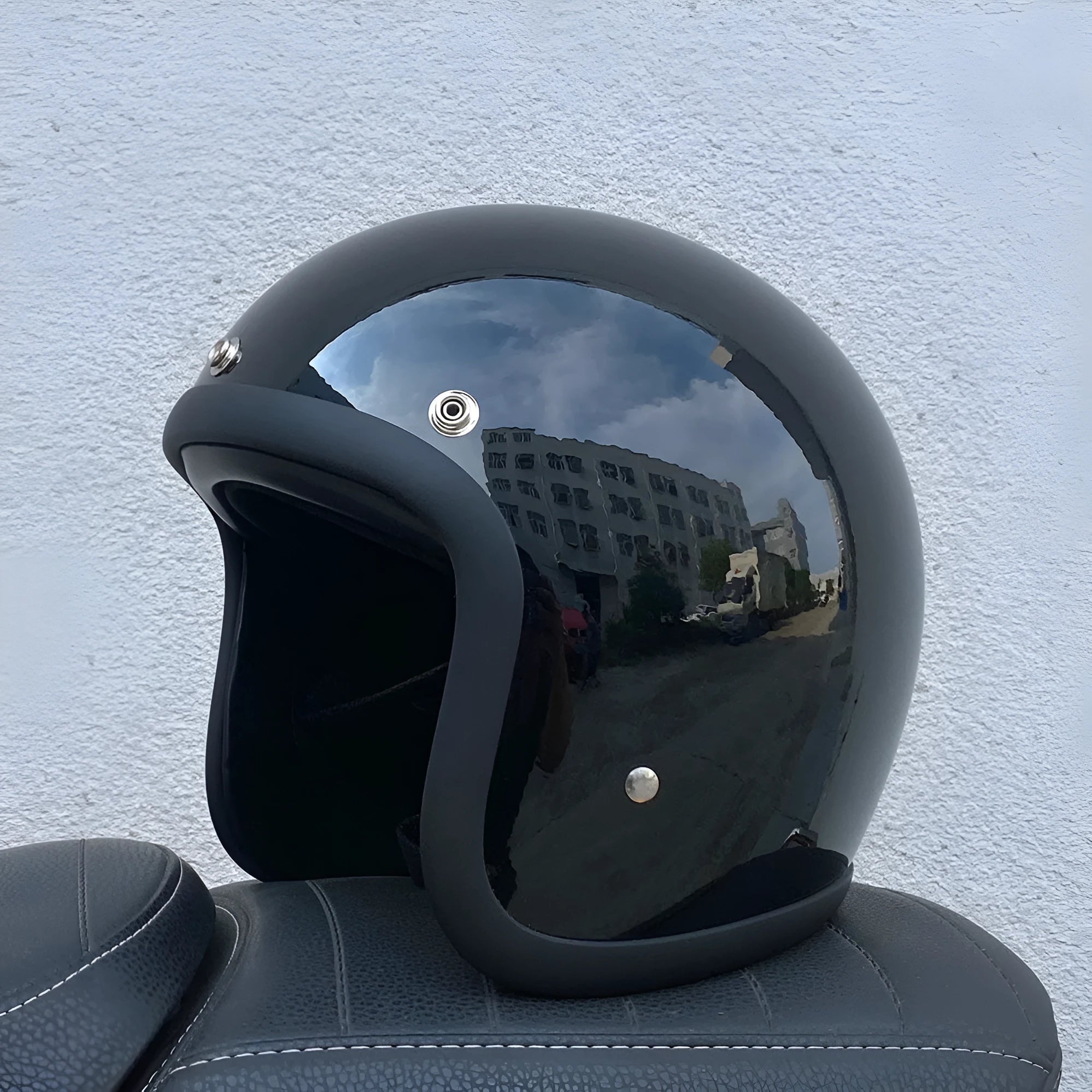 Retro style fibreglass half motorcycle helmet shown in a choice of colours like cement grey and matte black.