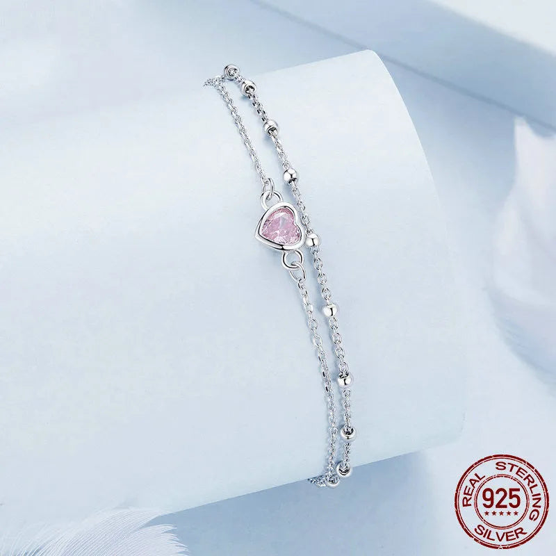 Sweet girlish 925 sterling silver bracelet with small heart-shaped pendant on an adjustable chain.