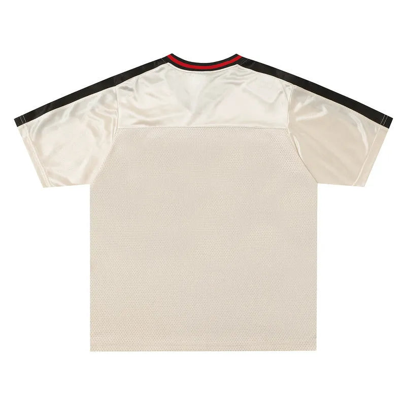 Apricot V-neck sports jersey top with lettered pattern and drop-shoulder sleeves laid flat