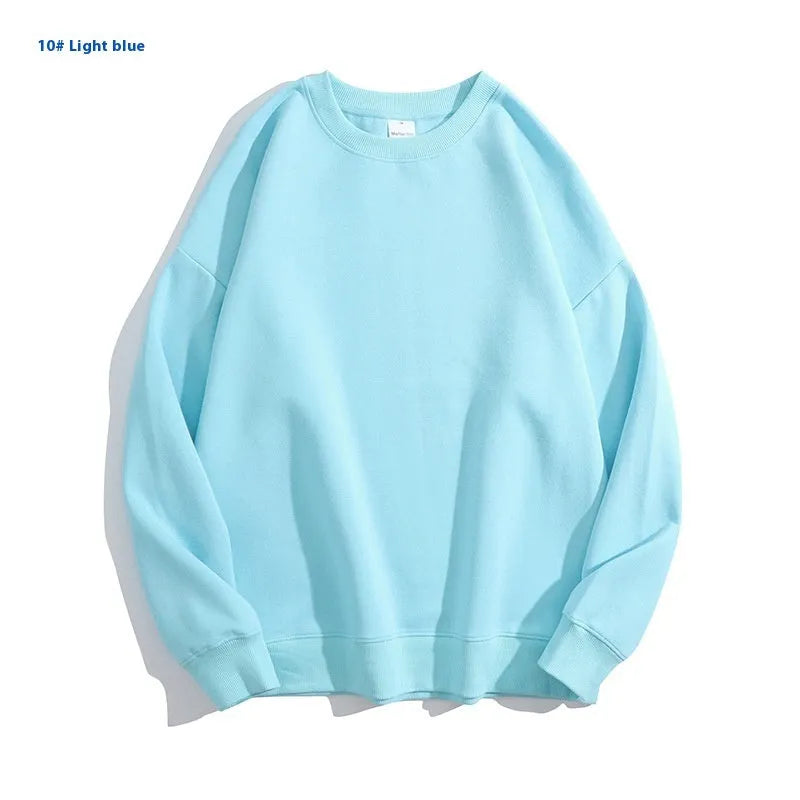 A woman wearing a loose-fit, off shoulder, long sleeve cotton pullover sweater in a solid colour.