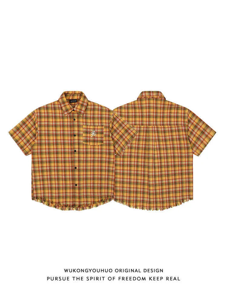 Yellow and white plaid short sleeve shirt with embroidery detail on chest pocket.