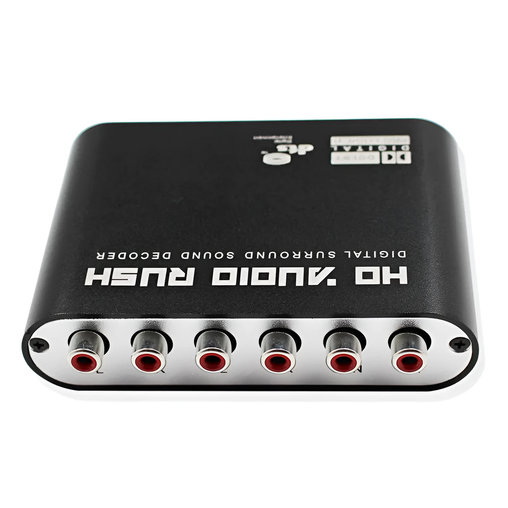 Black DTS Dolby AC-3 audio decoder unit with optical and coaxial inputs on a desk.