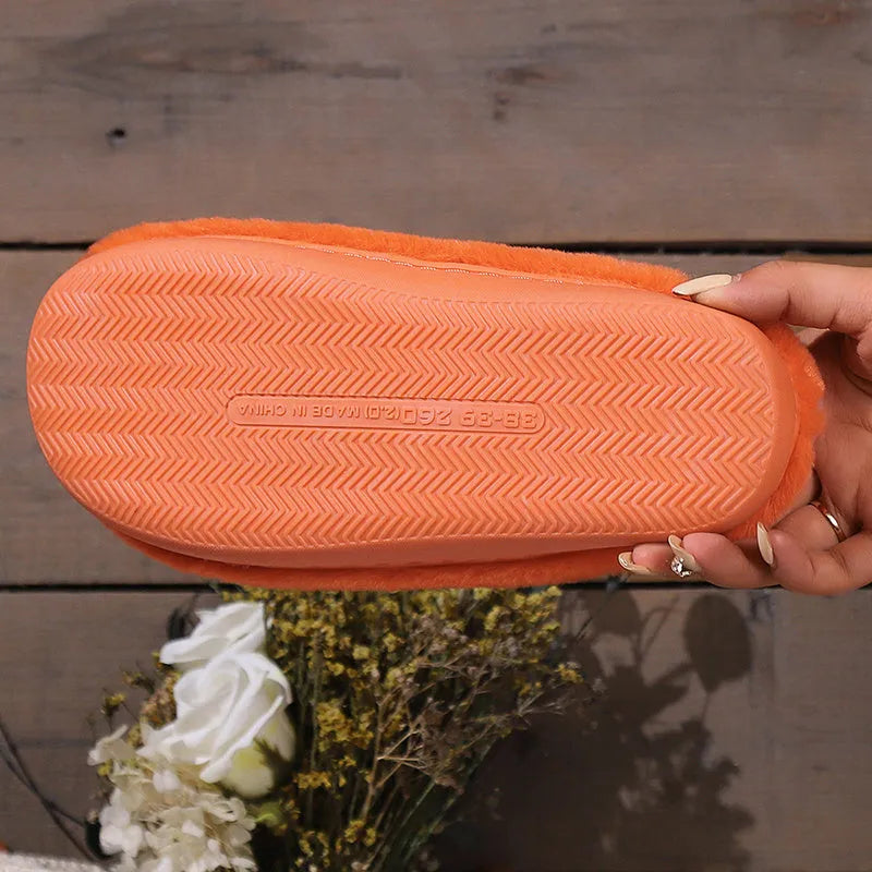 Orange Halloween pumpkin design slippers with plush lining and a textured PVC sole.