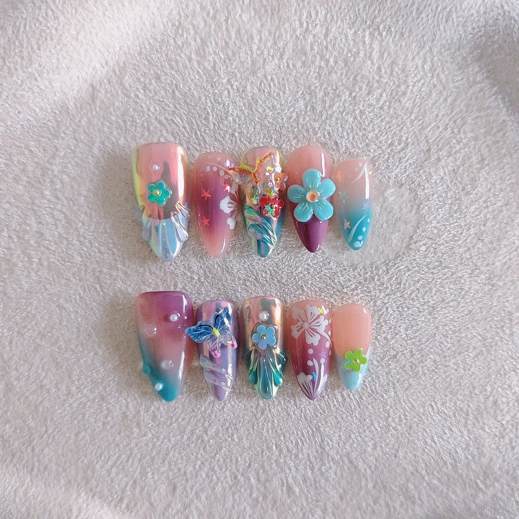 Handmade floral and butterfly nail art sculptures for manicure decoration in almond shape.