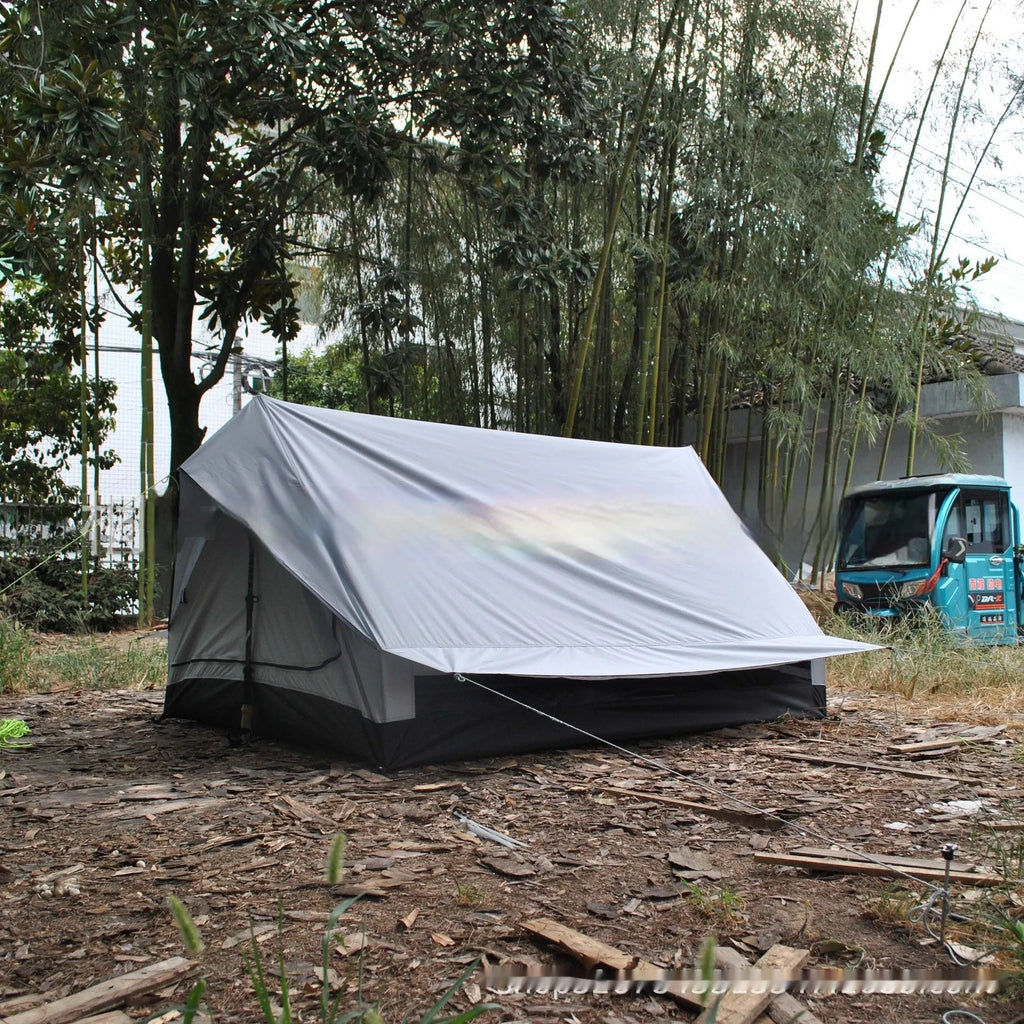 Brown A-line pole-free cabin tent set up with hiking poles showing spacious interior for 2-3 campers