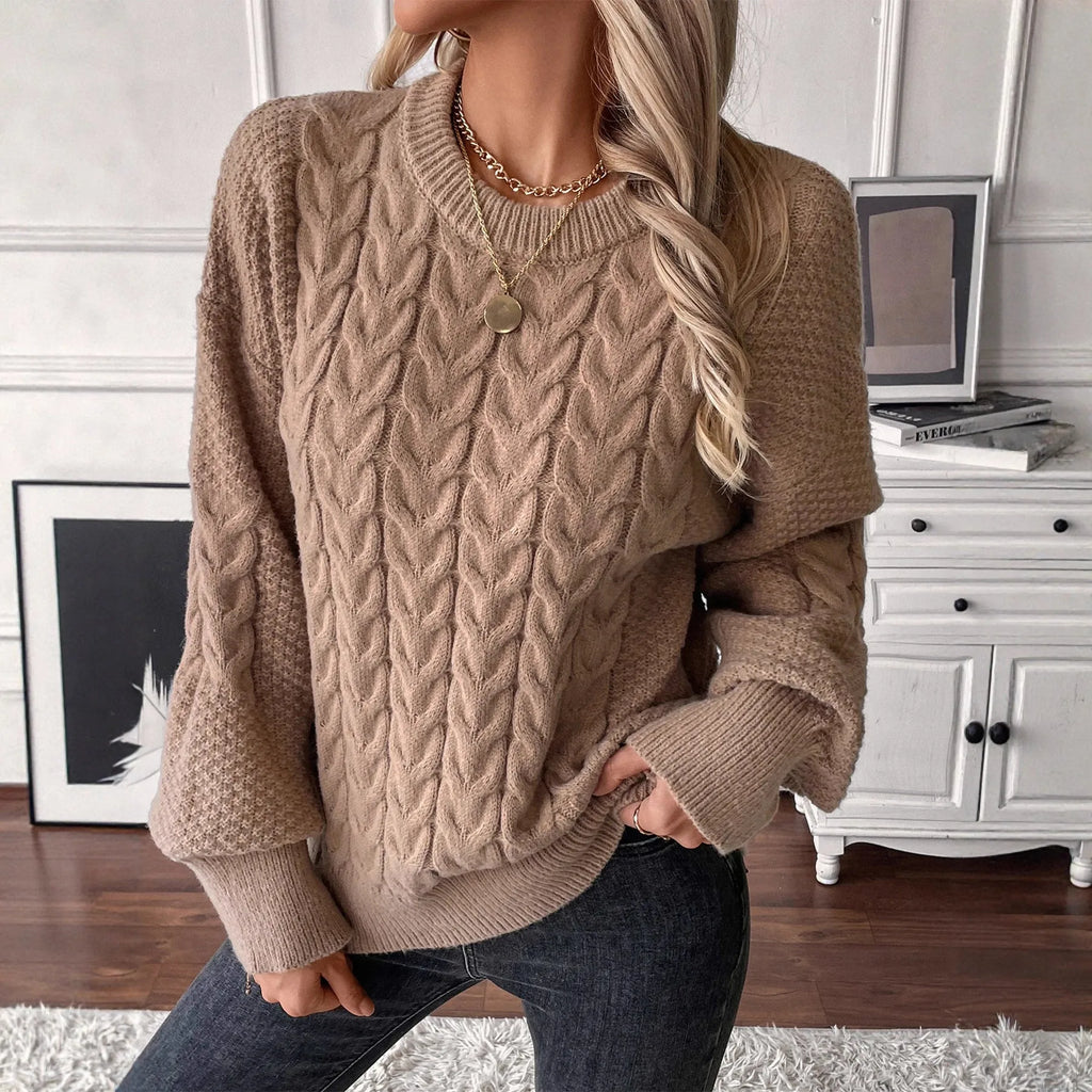 Women's loose beige round neck pullover sweater on a hanger.