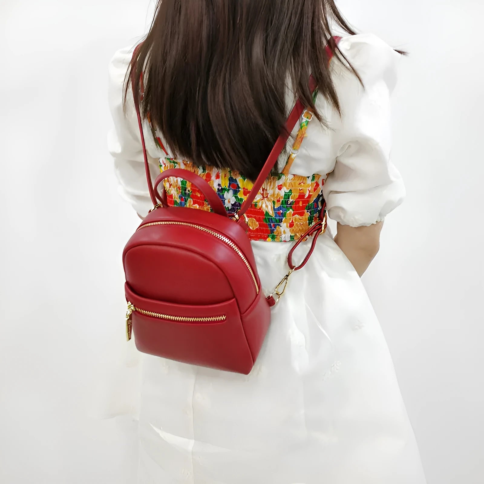 Soft PU mini backpack in street style with a three-dimensional front pocket, shown in multiple colour options.