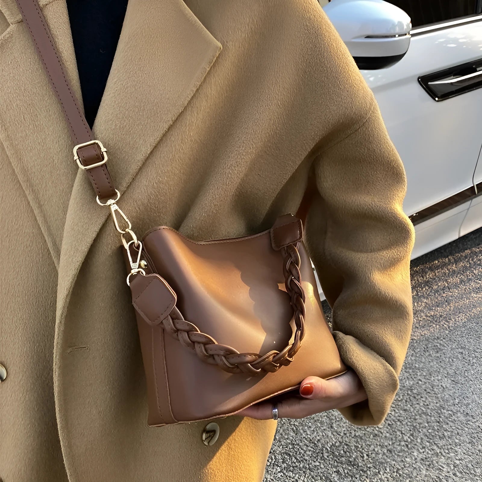Retro style brown PU leather underarm bucket bag with woven design detail.