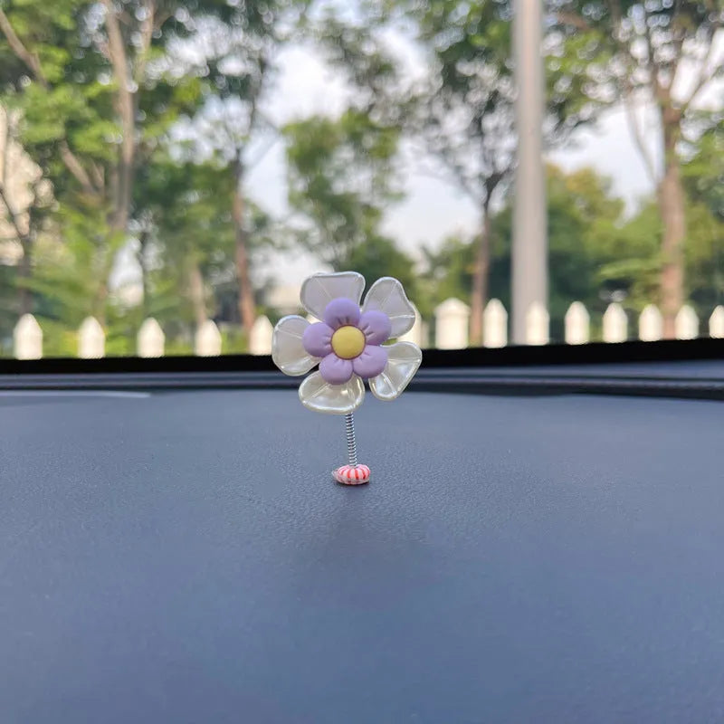 Small blue plastic swing-shaped car dashboard decoration.