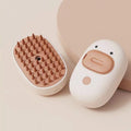 White and yellow rechargeable steam pet brush for dogs and cats on a table