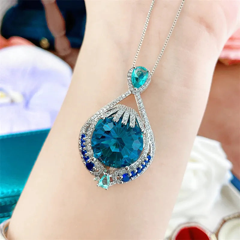 Blue geometric crystal necklace with fireworks-cut pendant on water wave chain