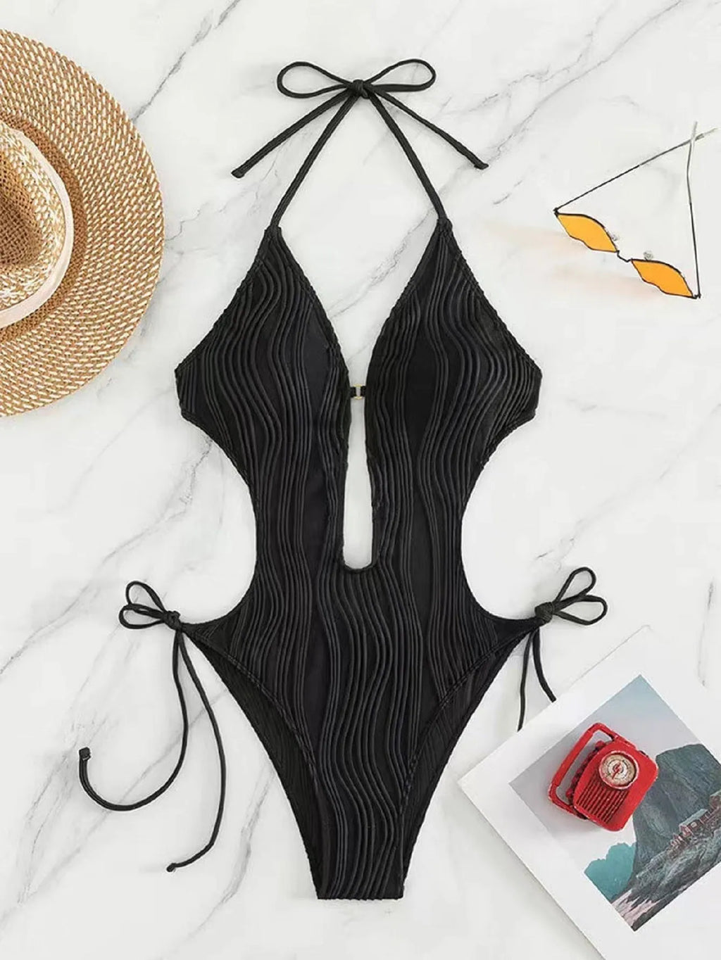 Women's black lace-up triangle bikini swimsuit on mannequin showing adjustable top details