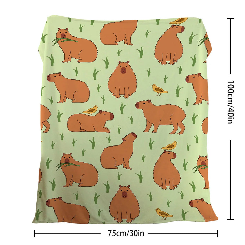 Multicolored flannel blanket with bird and capybara combined pattern on a sofa