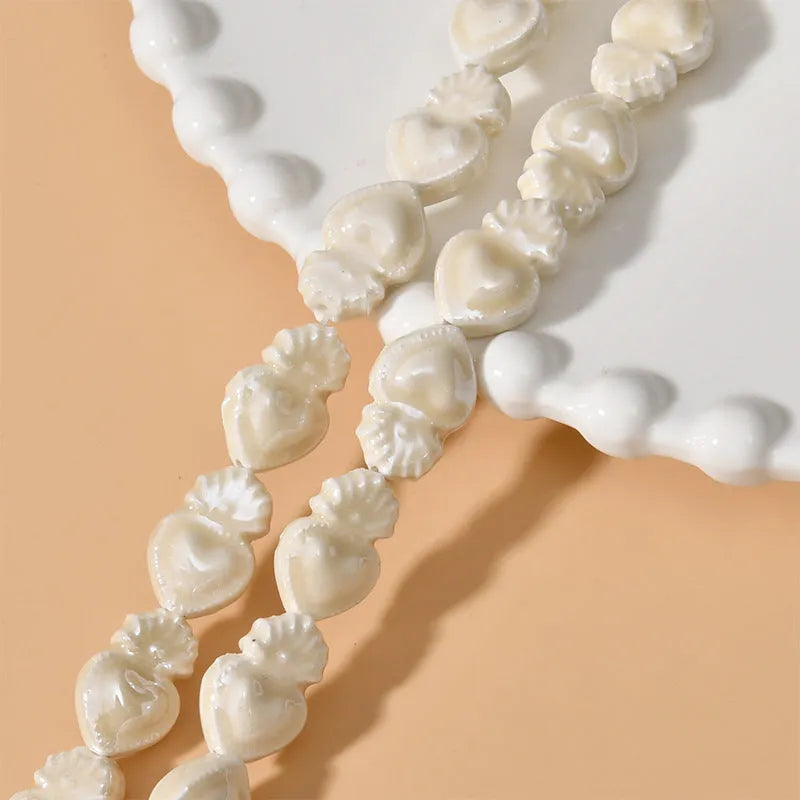 Ceramic love heart torch beads in multiple colours showing 10x15mm size and straight hole design
