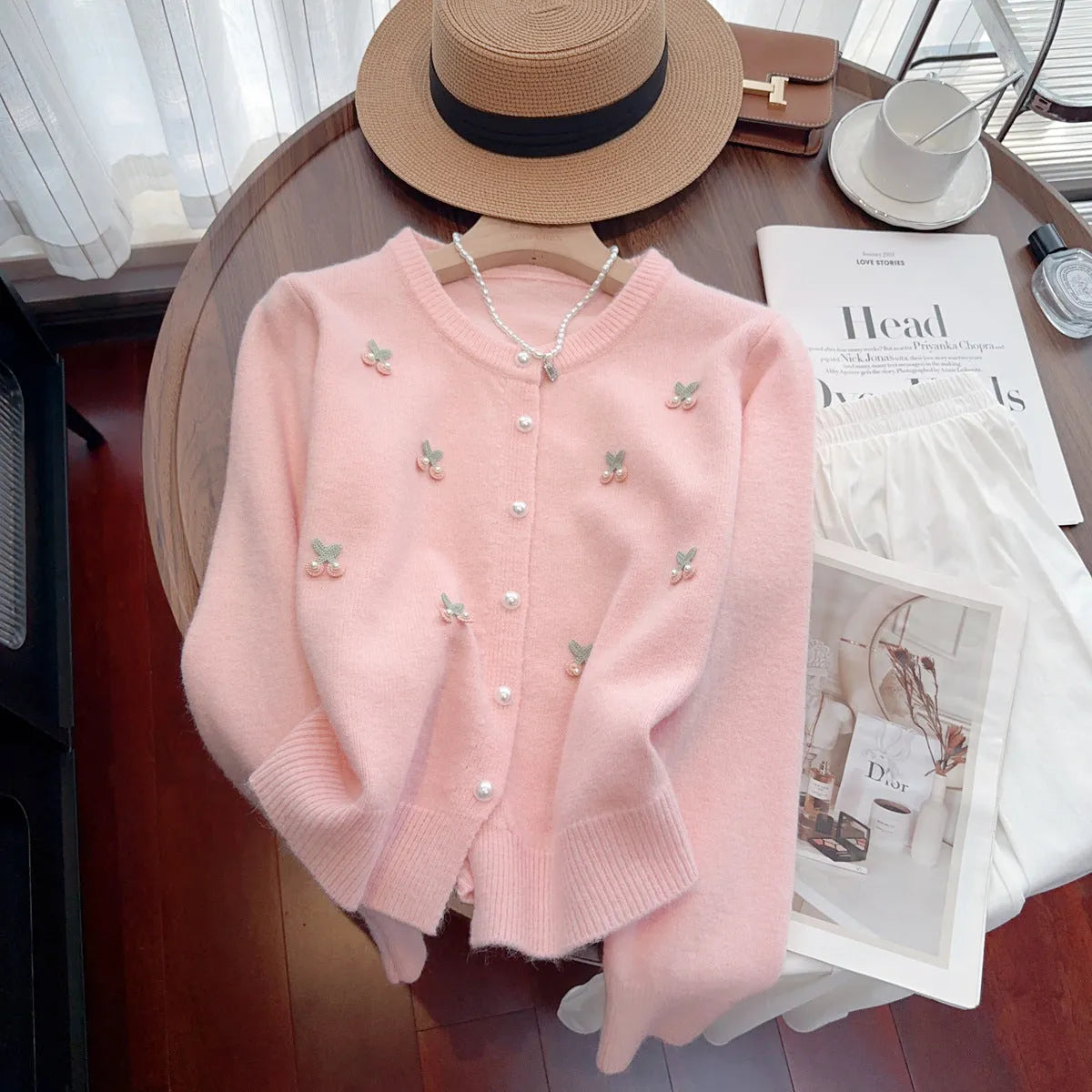 Slim-fit cashmere blend sweater coat with beaded detail on a hanger, shown in blue colour.