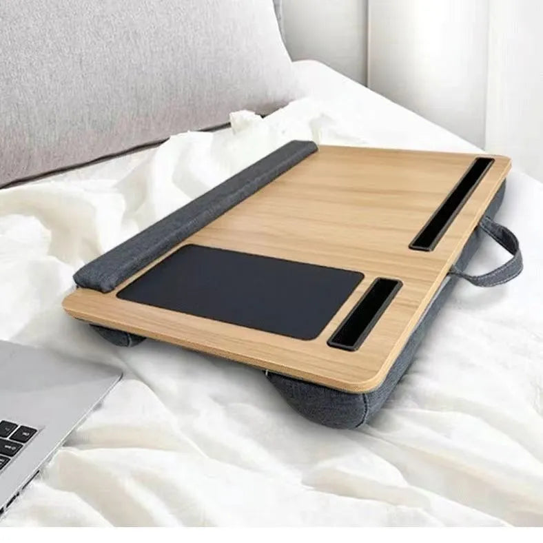 Foldable laptop bed desk with black walnut finish, open and ready for use on a bed
