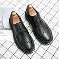 Men's black brogue leather shoes with round toe on a solid background