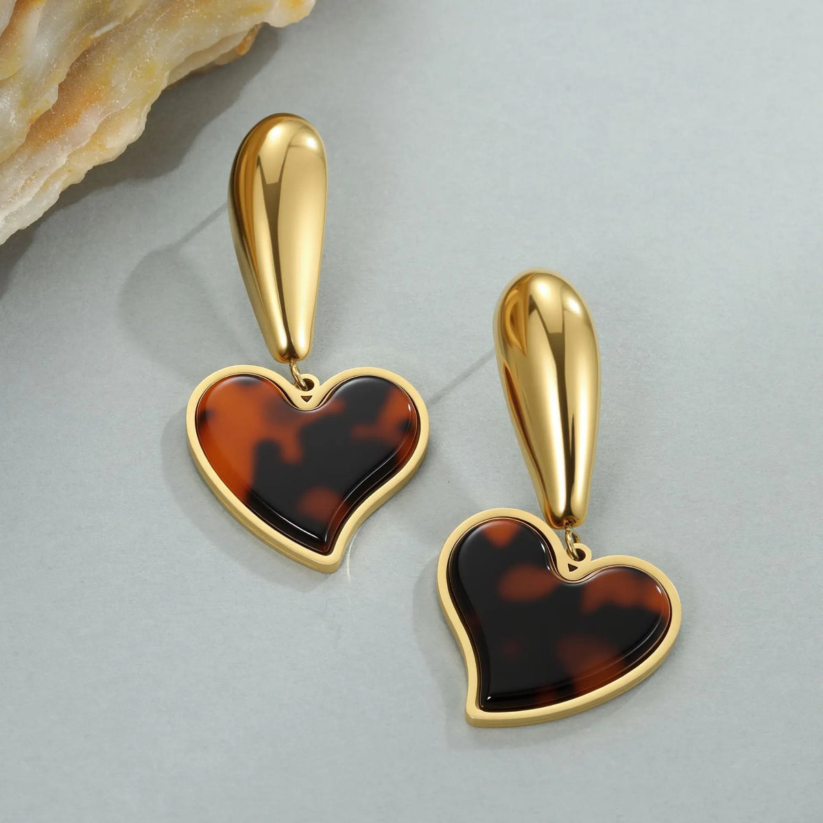 Gold electroplated tortoiseshell resin earrings in heart and flower designs on stainless steel
